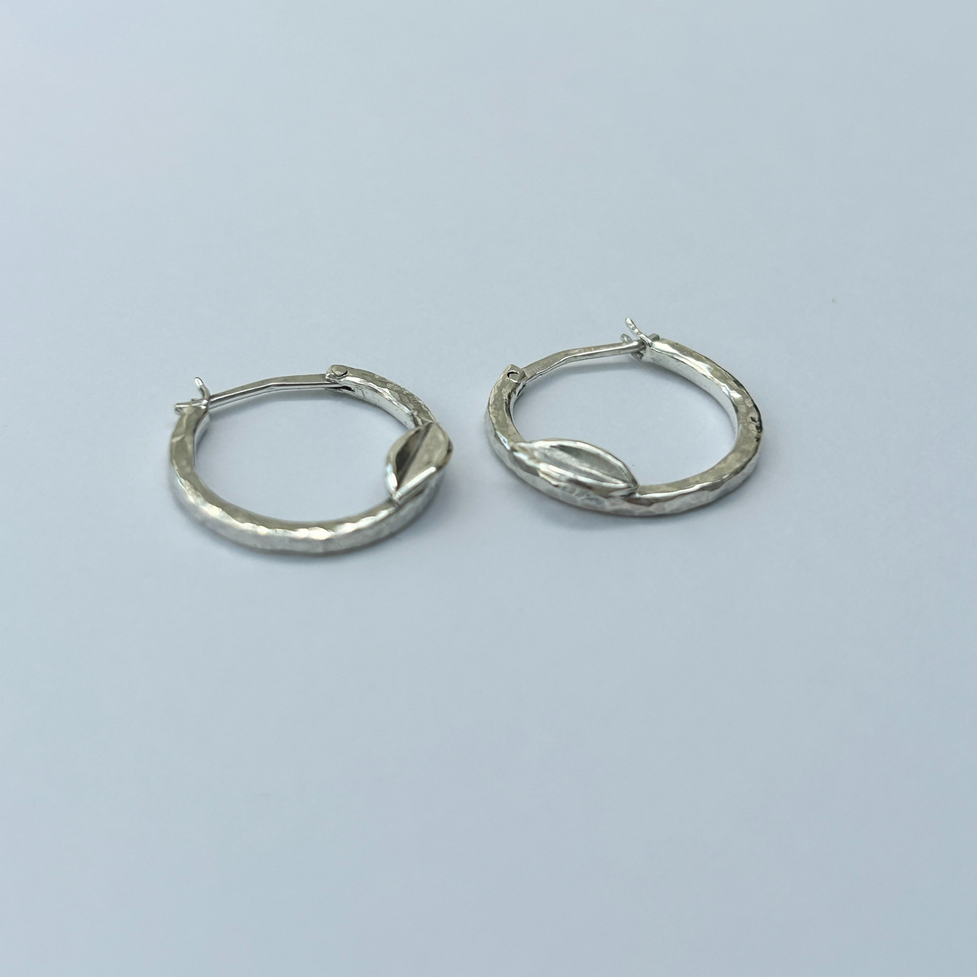 Handcrafted hammered silver hoop earrings with leaf detail – elegant artisan creoles for women