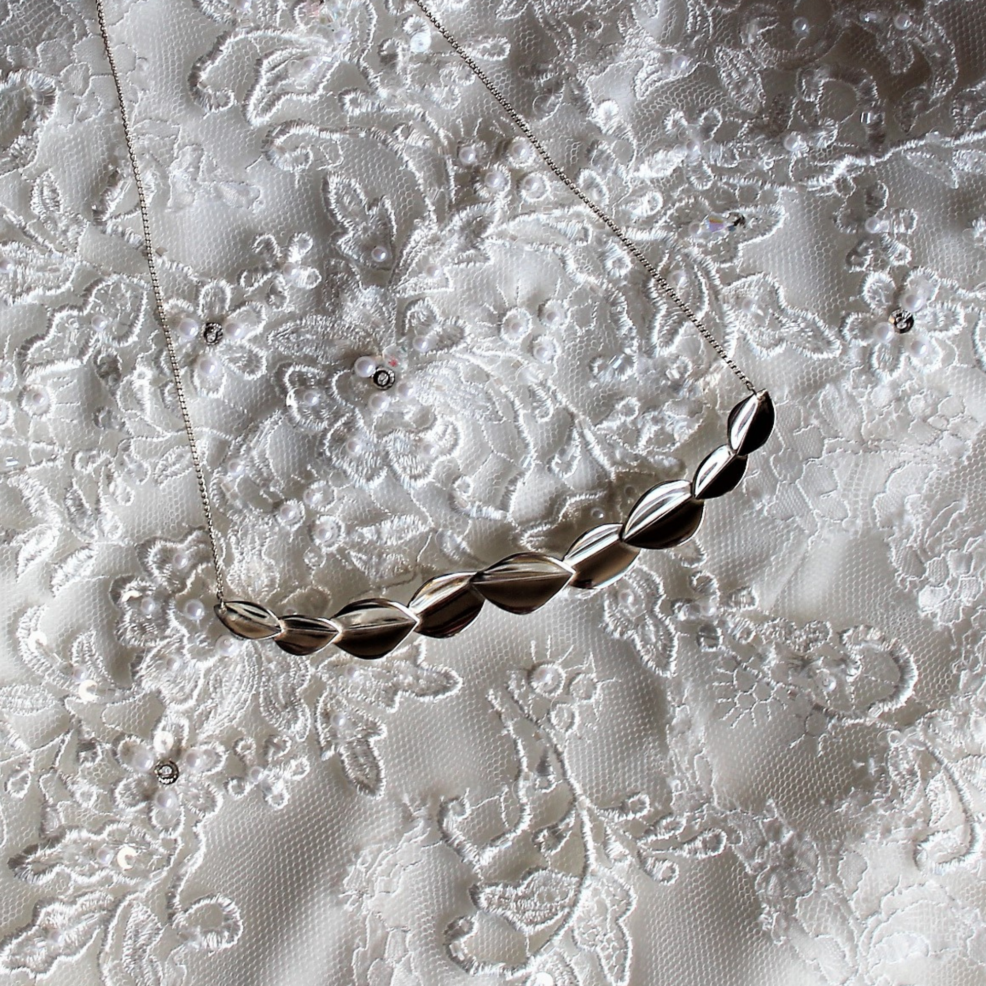 bridal 9 leaf silver necklace on lace wedding dress