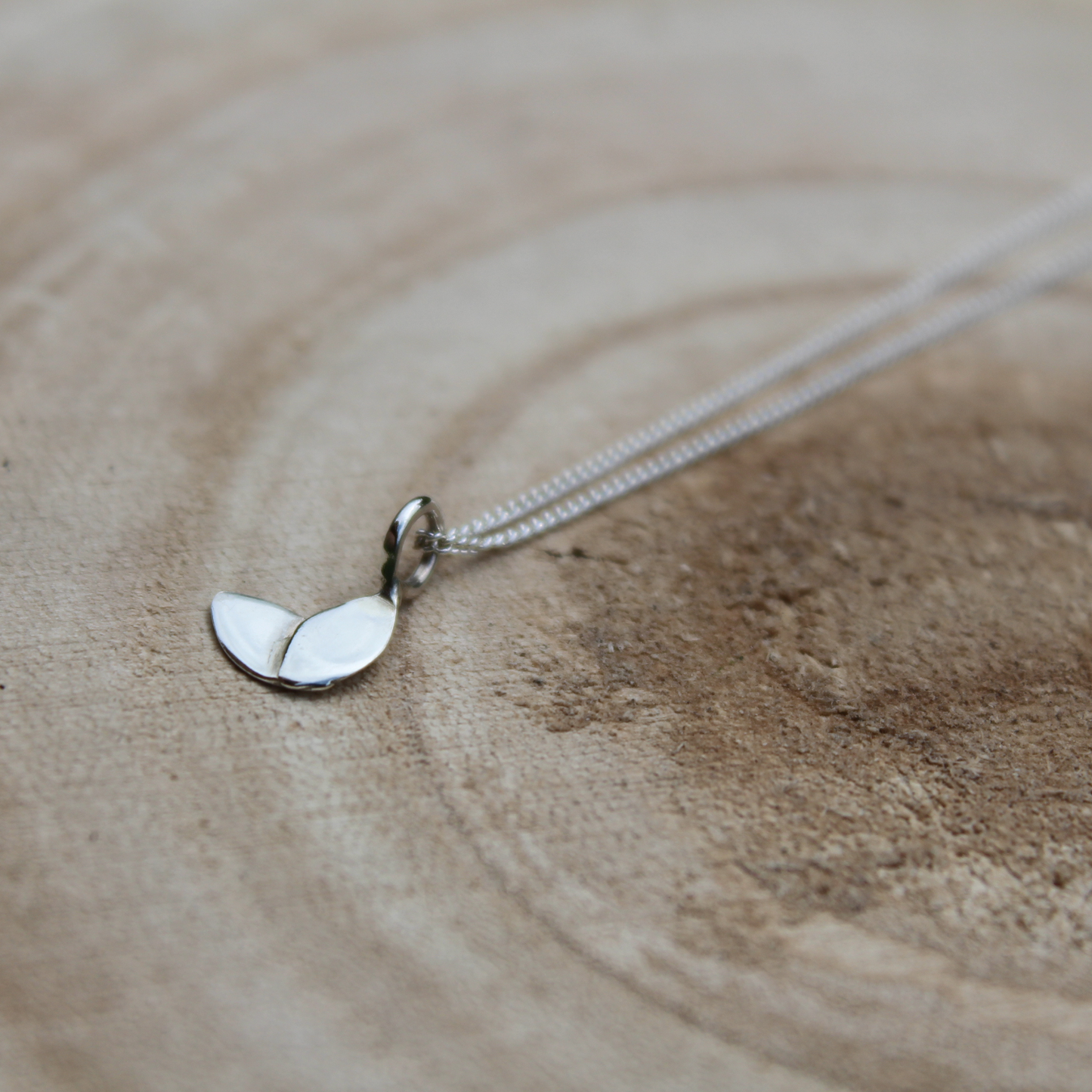 a silver plain small duo leaf necklace on wooden background - handmade by Jen Lithgo Jewellery
