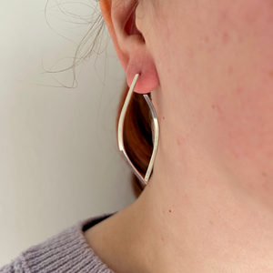 Sterling Silver silhouette outline leaf stud earring being worn in a Ladies ear, by Jen Lithgo Jewellery Designer