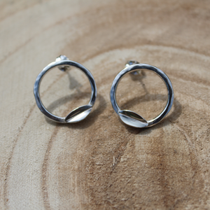 Hammered effect hoop stud earrings with folded leaf handmade from sterling silver on a wooden log - by Jen Lithgo Jewellery