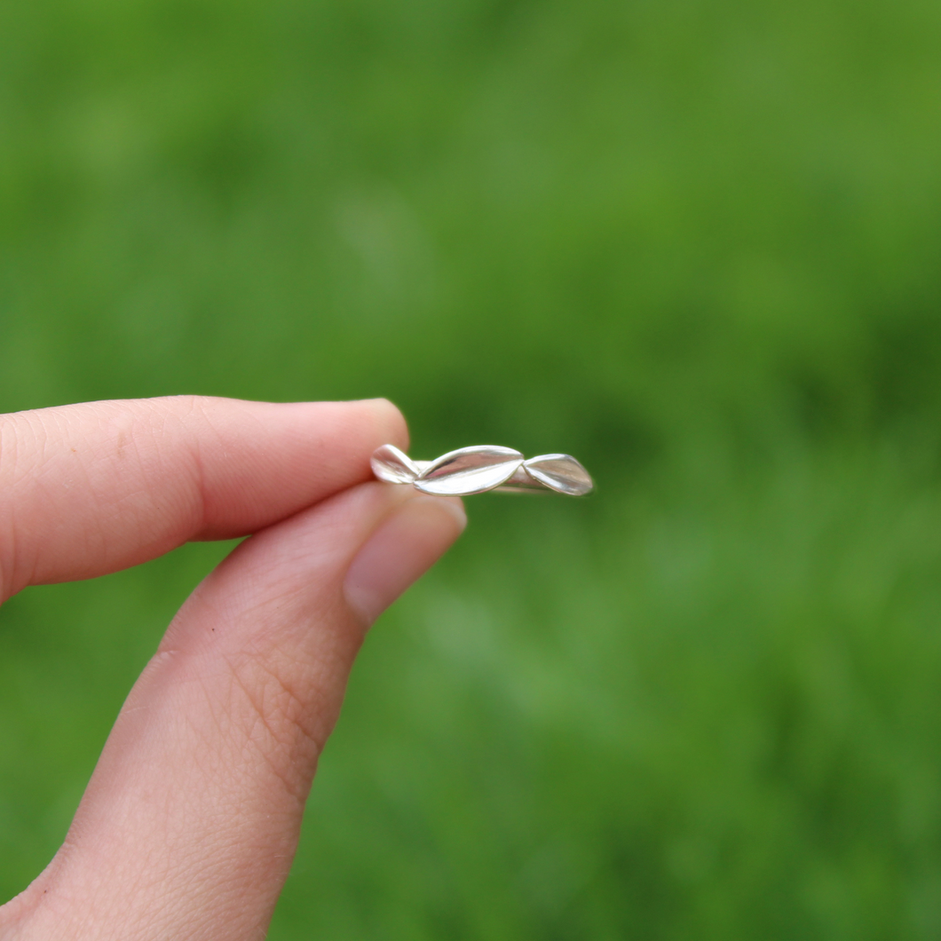 three leaf ring held in fingers