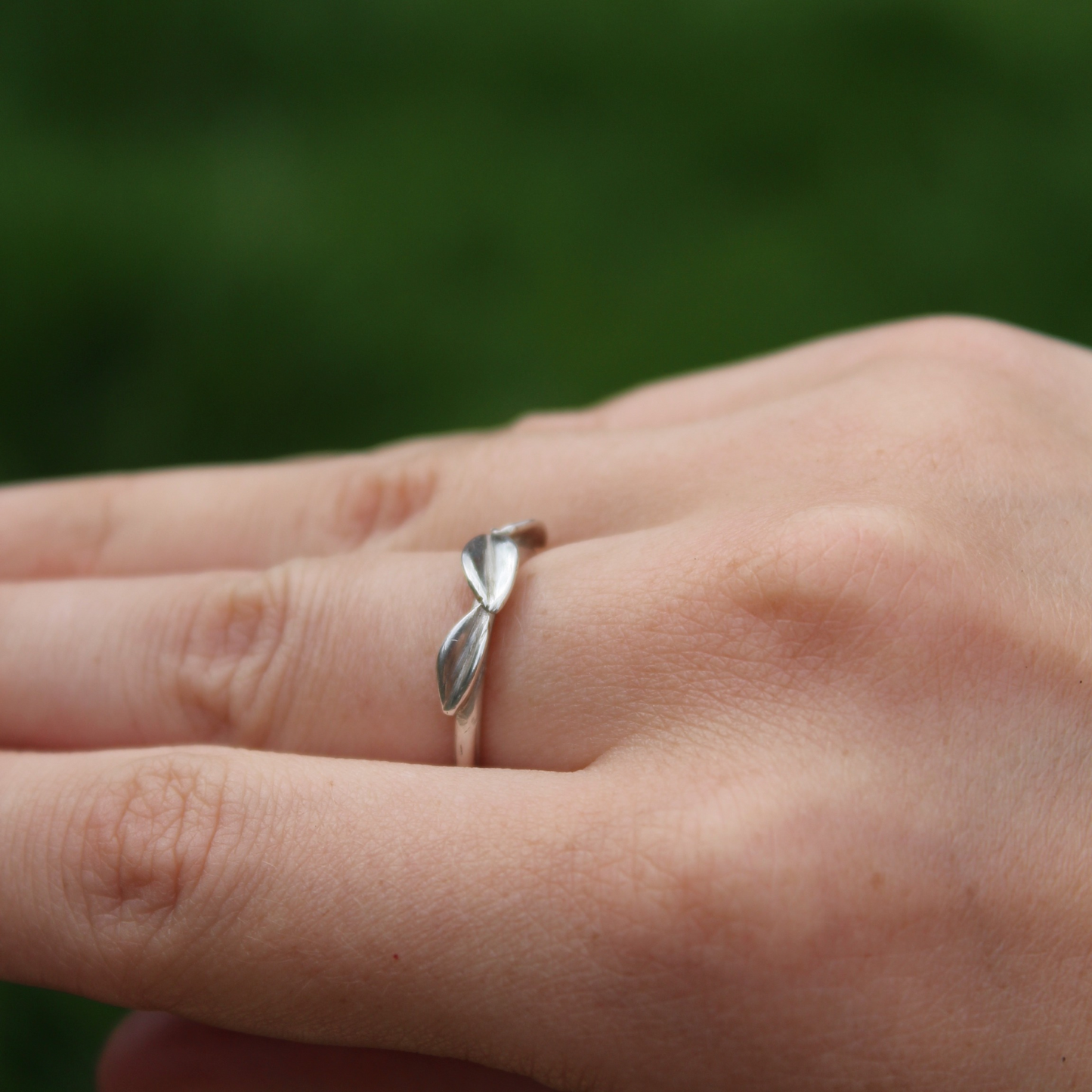 three leaf ring on a hand