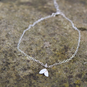 Duo leaf silver bracelet on a stone