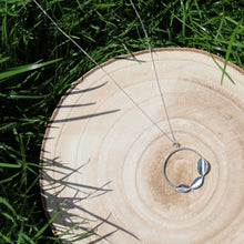 Load image into Gallery viewer, Wooden log on grass with sterling silver three leaves on a hoop necklace hanging on a curb chain, handmade by Jen Lithgo Jewellery