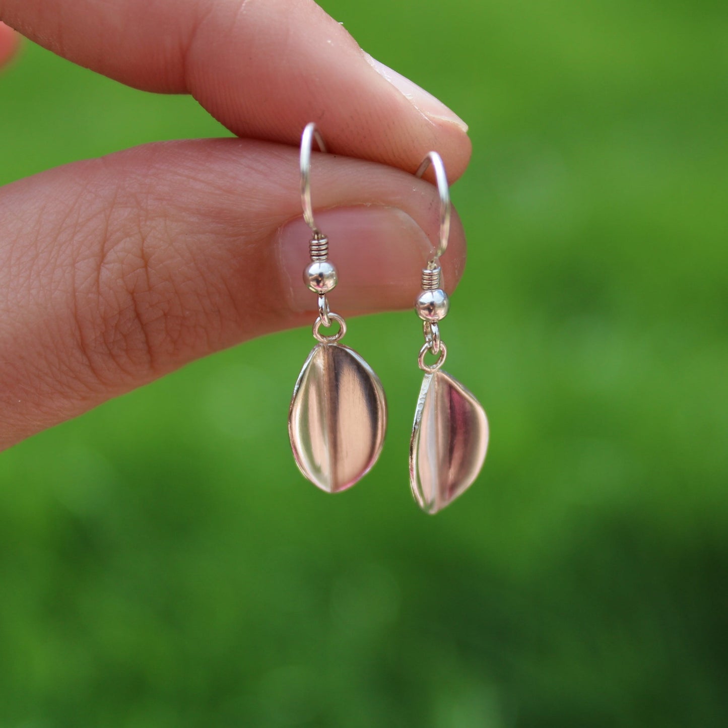 Small Leaf Drop Earrings being held by a ladies hand - handmade by Jen Lithgo Jewellery