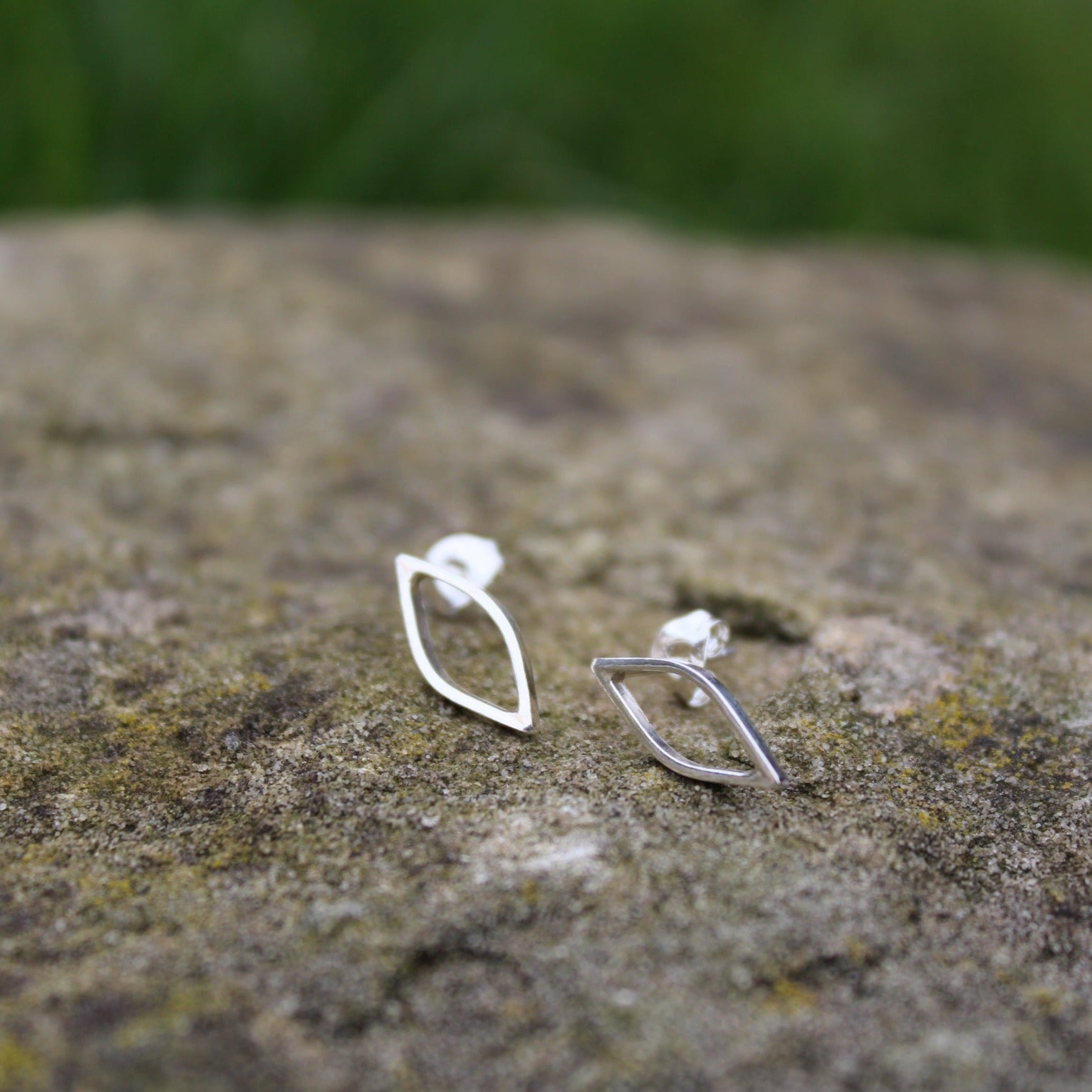 Close up of Outline leaf stud earrings silhouette of a leaf shape on a rock - handmade by Jen Lithgo Jewellery