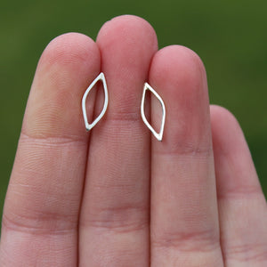 Womans hand holding outline sterling silver stud earrings handmade by Jen Lithgo Jewellery Designer